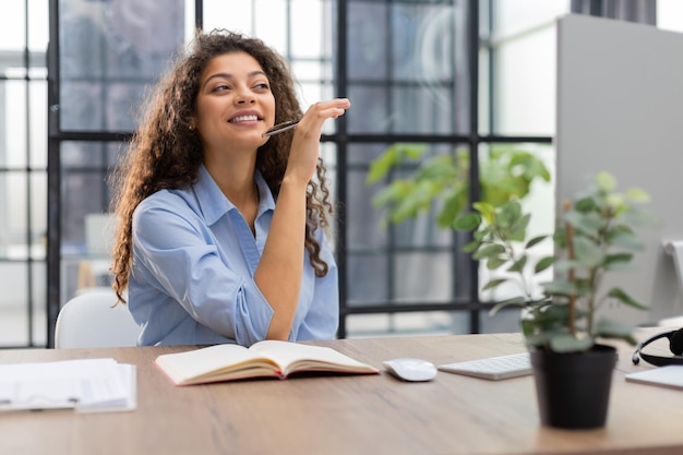 Smiling businesswoman looking at camera make conference or business call recording video blog talking with client