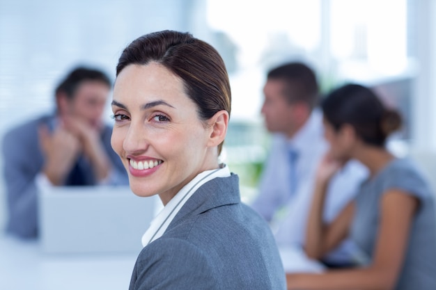 Smiling businesswoman looking at camera