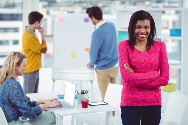 Smiling businesswoman near her colleagues