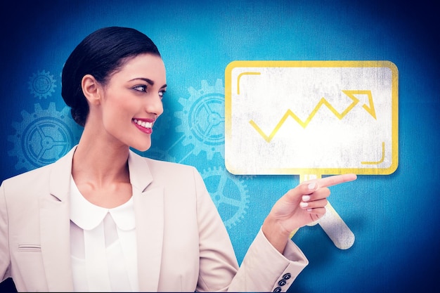 Photo smiling businesswoman pointing  against blue background