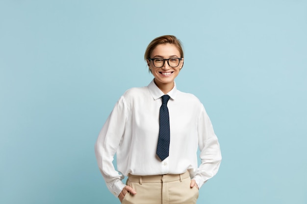 Smiling businesswoman posing studio portrait of happy woman standing smiling