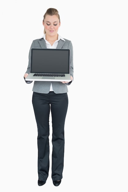 Smiling businesswoman presenting a notebook