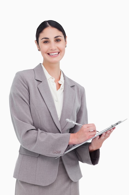 Smiling businesswoman ready to take notes against a white background