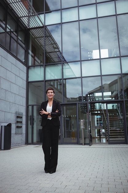 Smiling businesswoman standing in office premises