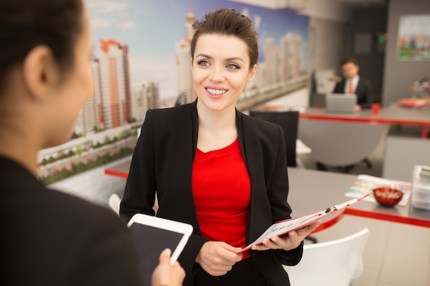 Smiling Businesswoman Talking to Colleague