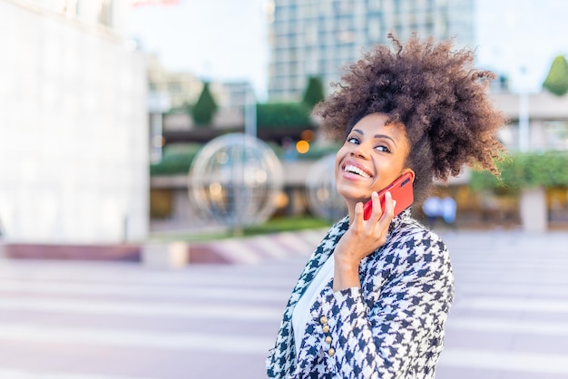 Smiling businesswoman talking on the phone in the city