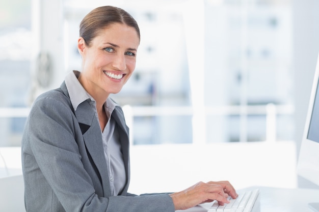 Smiling businesswoman using computer  