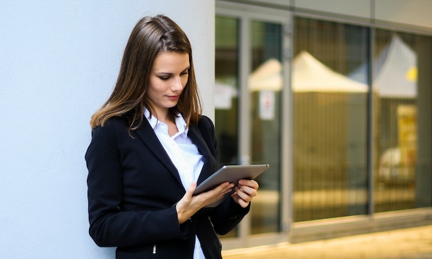 Smiling businesswoman using a digital tablet outdoor