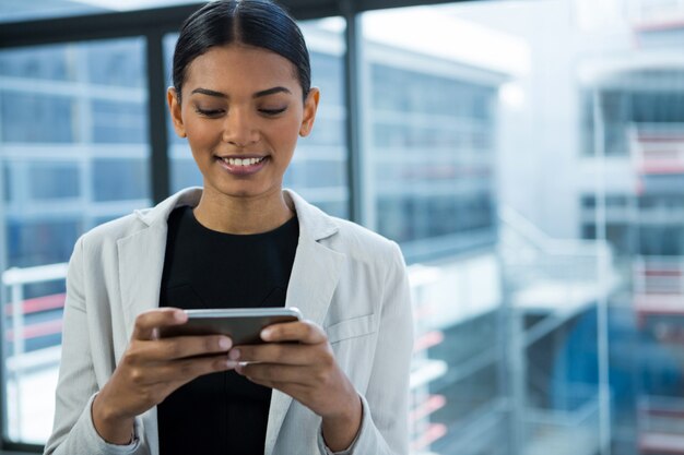 Smiling businesswoman using mobile phone