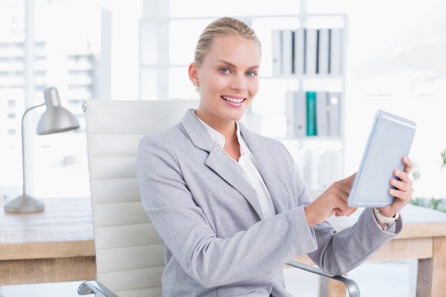 Smiling businesswoman using tablet 
