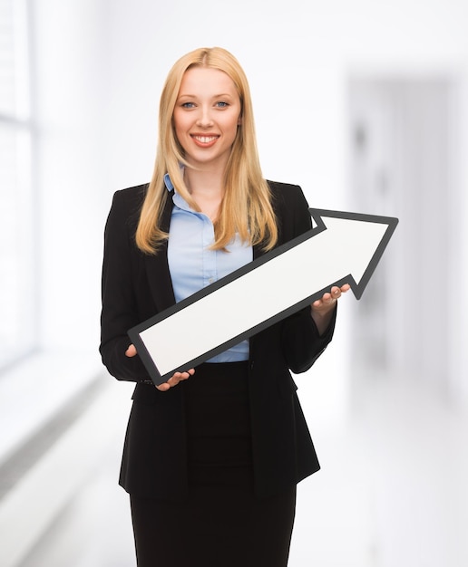 smiling businesswoman with direction arrow sign