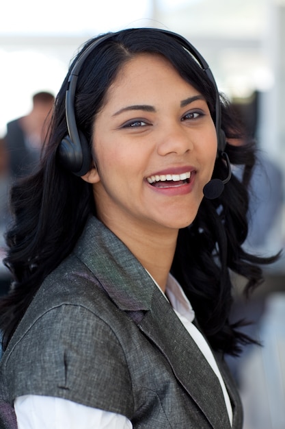 Smiling businesswoman with a headset on in company