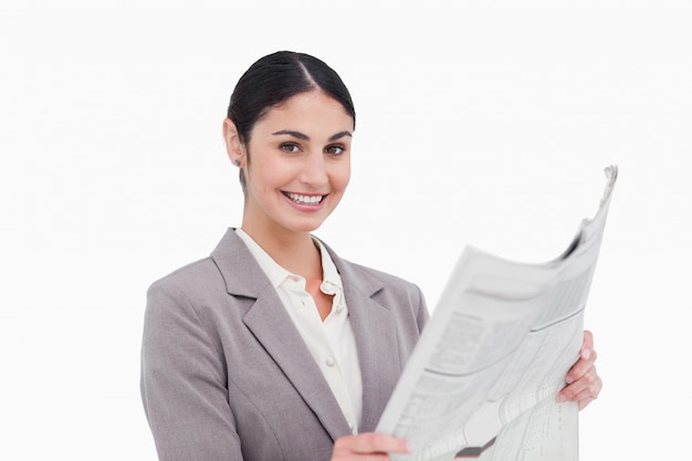 Smiling businesswoman with news paper