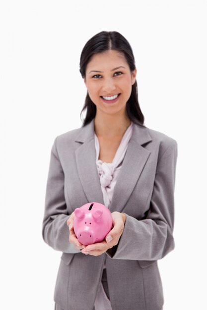 Smiling businesswoman with piggy bank