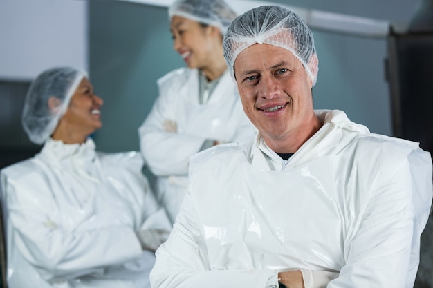 Smiling butcher standing with arms crossed