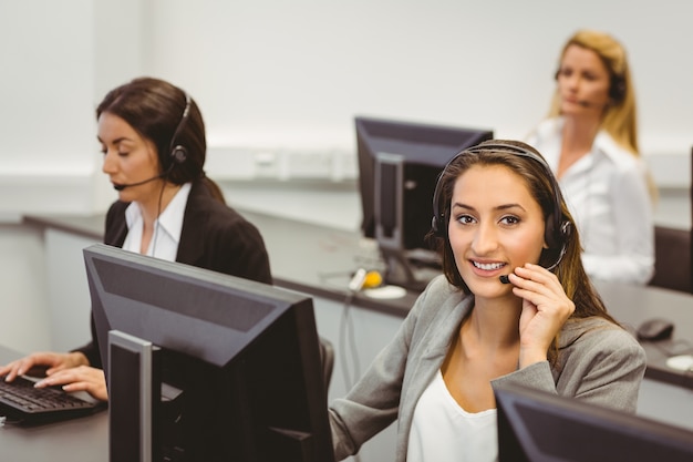 Smiling call centre agent talking on the headset