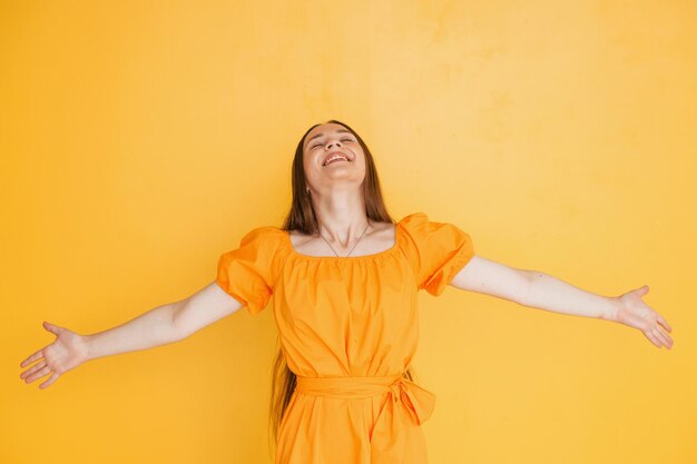 Smiling for the camera Young woman in casual clothes standing indoors in the studio