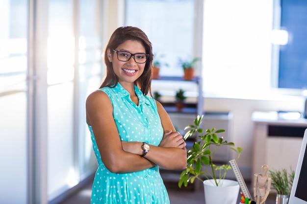 Smiling casual businesswoman posing with arms crossed