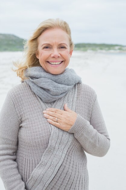 Smiling casual senior woman at beach