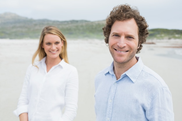 Smiling casual young couple at beach