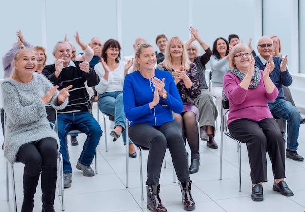 Smiling charismatic speaker giving public presentation in conference hall