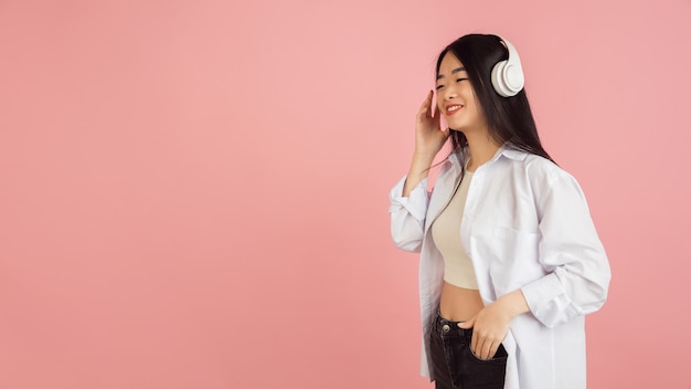 Smiling, cheerful. Asian young woman's portrait. Beautiful female model in casual style.