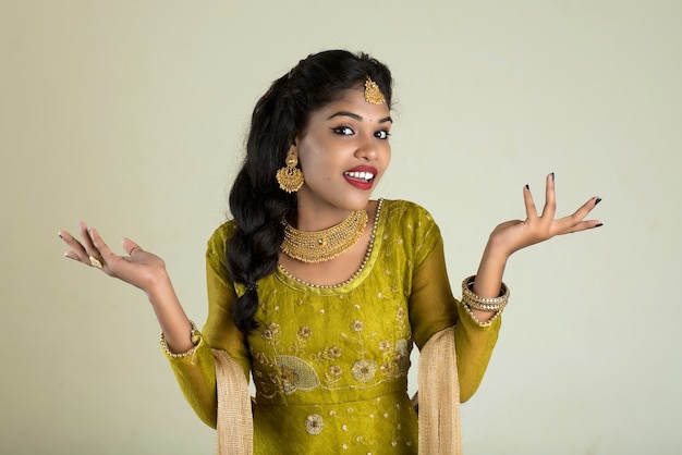 Smiling cheerful girl showing sign isolated on white background