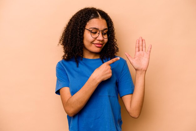 Smiling cheerful showing number five with fingers