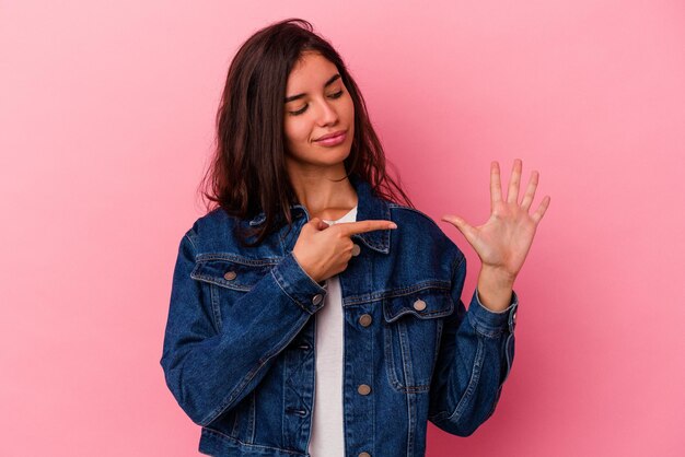 Smiling cheerful showing number five with fingers