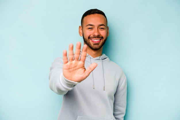 Smiling cheerful showing number five with fingers