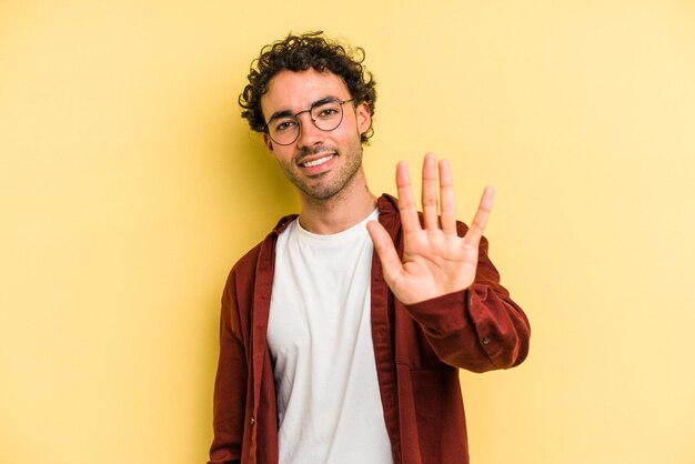 Smiling cheerful showing number five with fingers