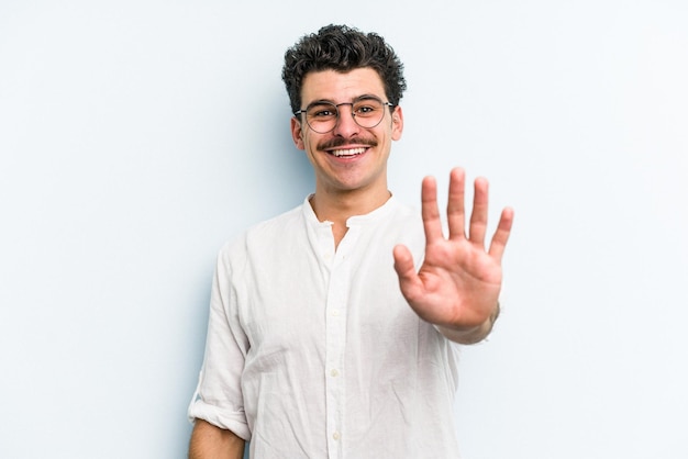 Smiling cheerful showing number five with fingers