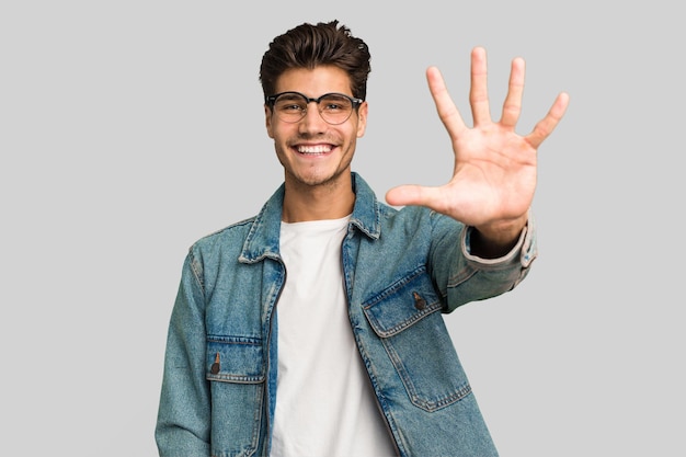 Smiling cheerful showing number five with fingers