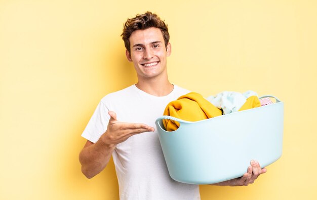 Smiling cheerfully, feeling happy and showing a concept in copy space with palm of hand. washing clothes concept