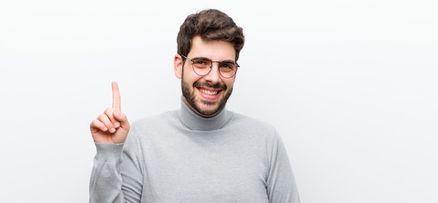 smiling cheerfully and happily, pointing upwards with one hand