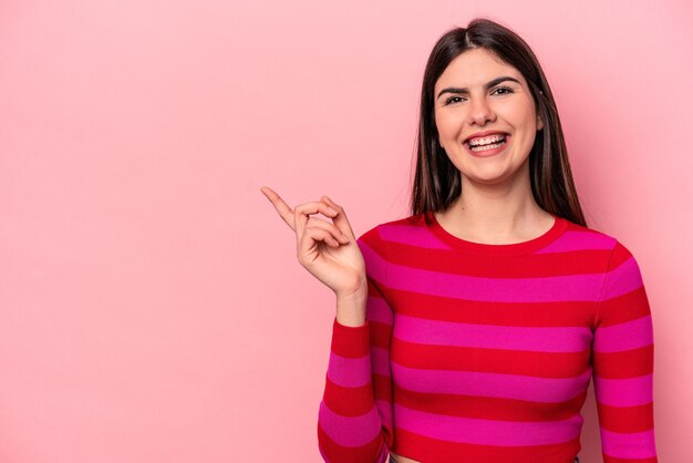 Smiling cheerfully pointing with forefinger away