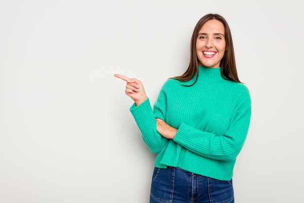 Smiling cheerfully pointing with forefinger away