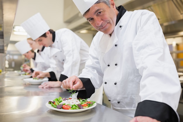 Smiling Chef&#039;s preparing their salads