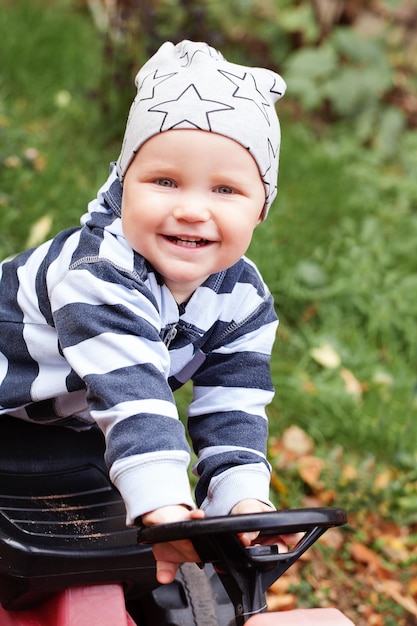 Smiling child playing outdoors in playground portrait