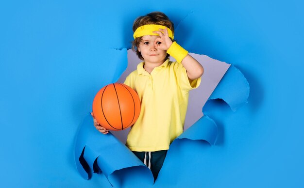 Smiling child with basketball ball showing sign ok excellent symbol kid boy with basket ball looking