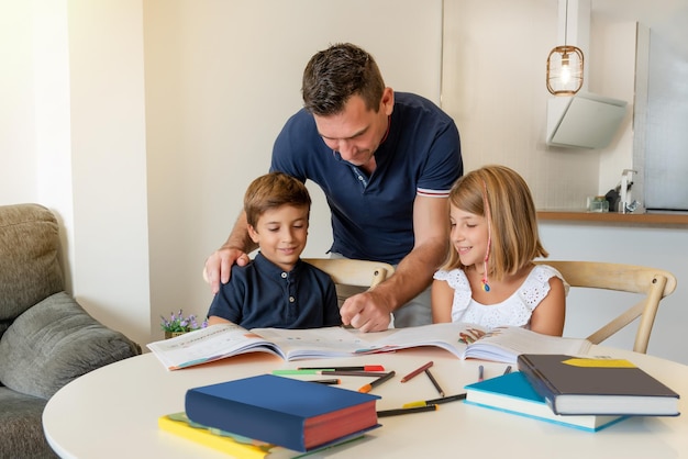 Bambini sorridenti che disegnano e studiano a casa con un tutor privato lezioni personalizzate per bambini