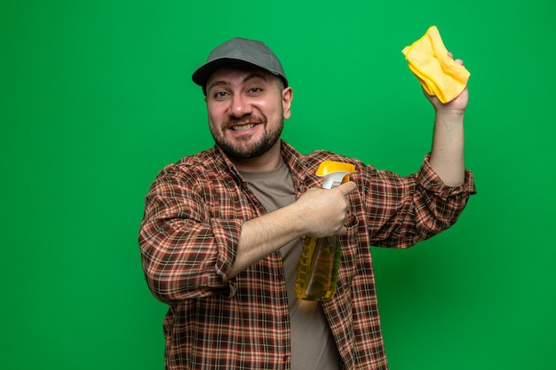 Smiling cleaner man holding cleaning cloths and spray cleaner 