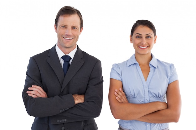 Smiling co workers standing next to each other