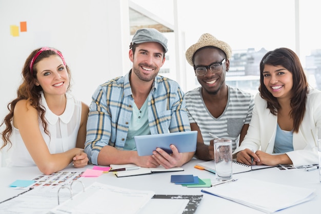 Smiling colleagues using digital tablet