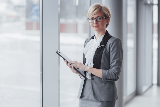 Smiling confident business woman looking at camera at office