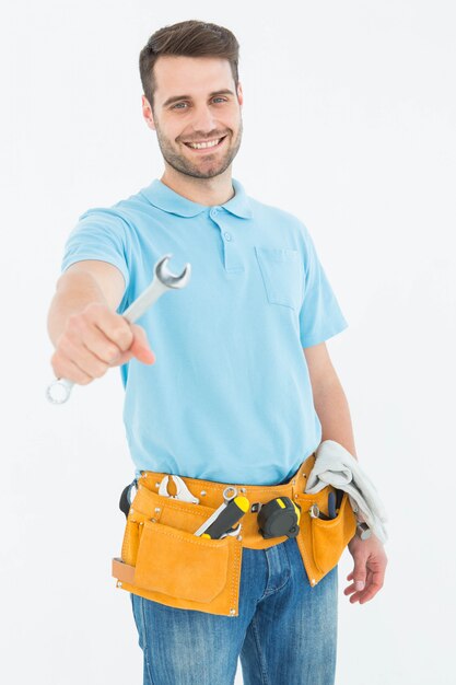 Smiling construciton worker holding wrench