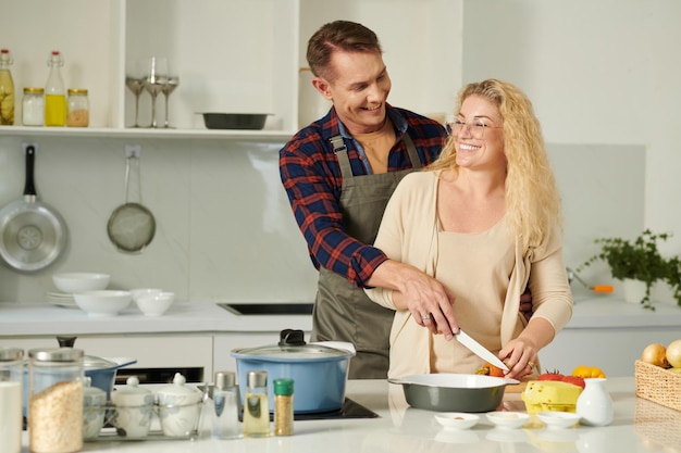 Smiling Couple Cutting Vegetables