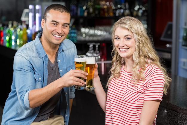 Smiling couple drinking beer