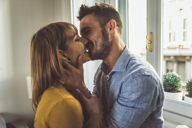 smiling couple embracing at home