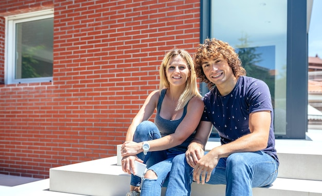 Smiling couple in front of their new house